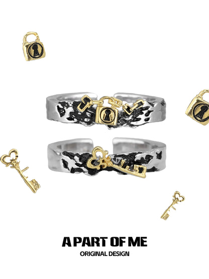 A PART OF ME hell lock ring featuring a unique design with key and padlock motifs in silver and gold