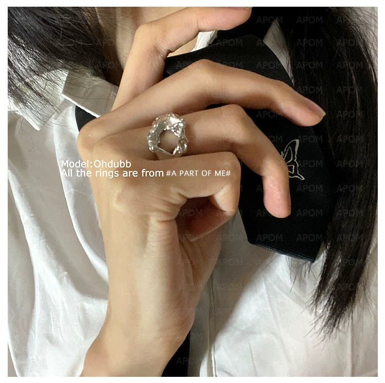 Woman wearing an imperfect beauty silver ring, showcasing its unique design and trendy style.