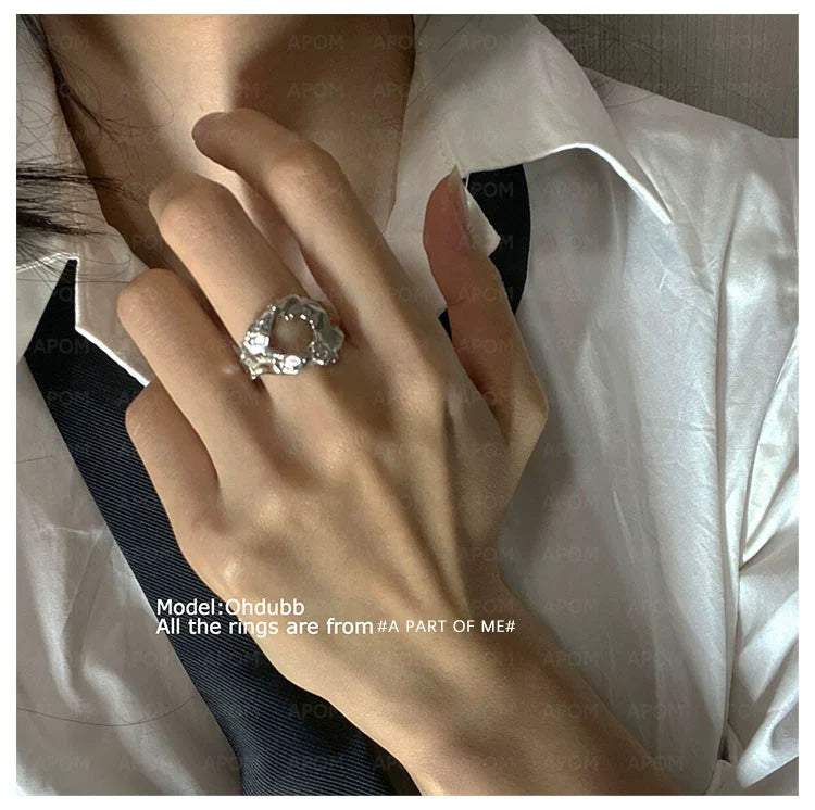 Imperfect beauty silver ring showcased on a hand wearing a white shirt and black tie