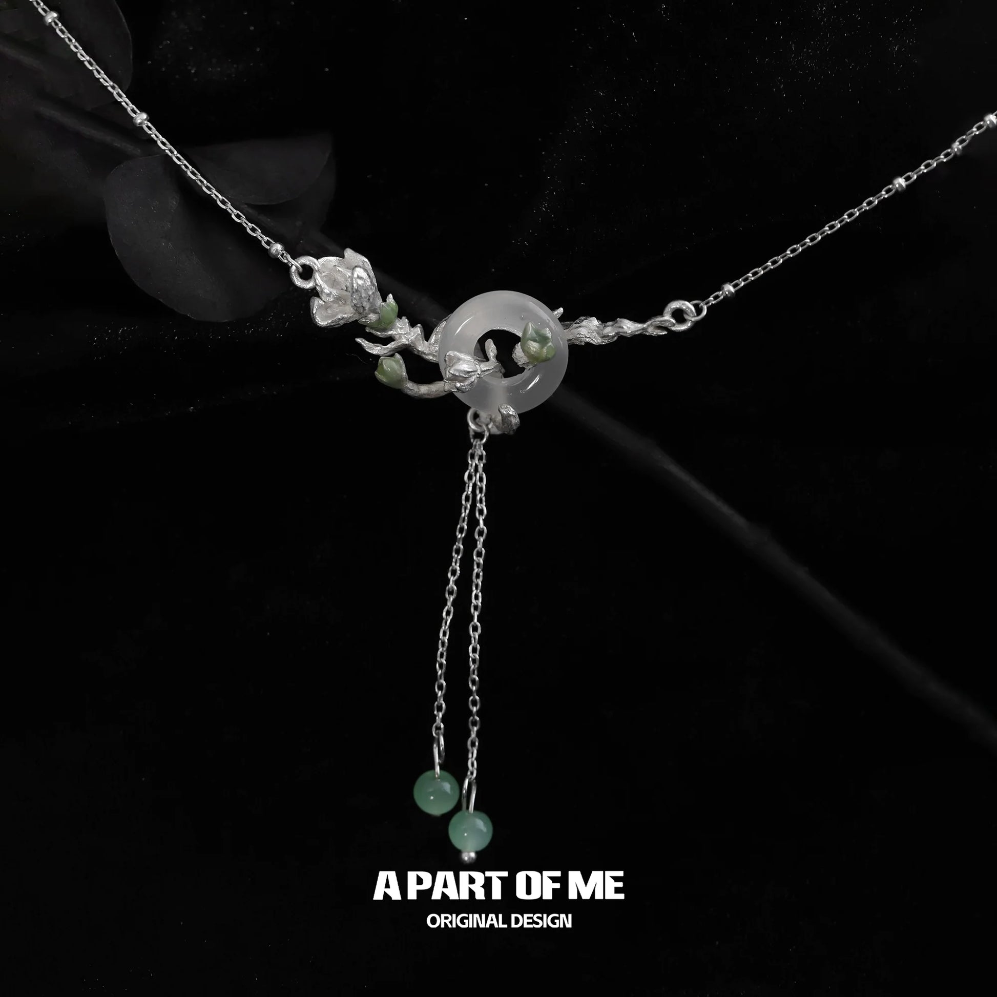 Jasmine silver necklace featuring intricate floral design and jade accents for elegant style