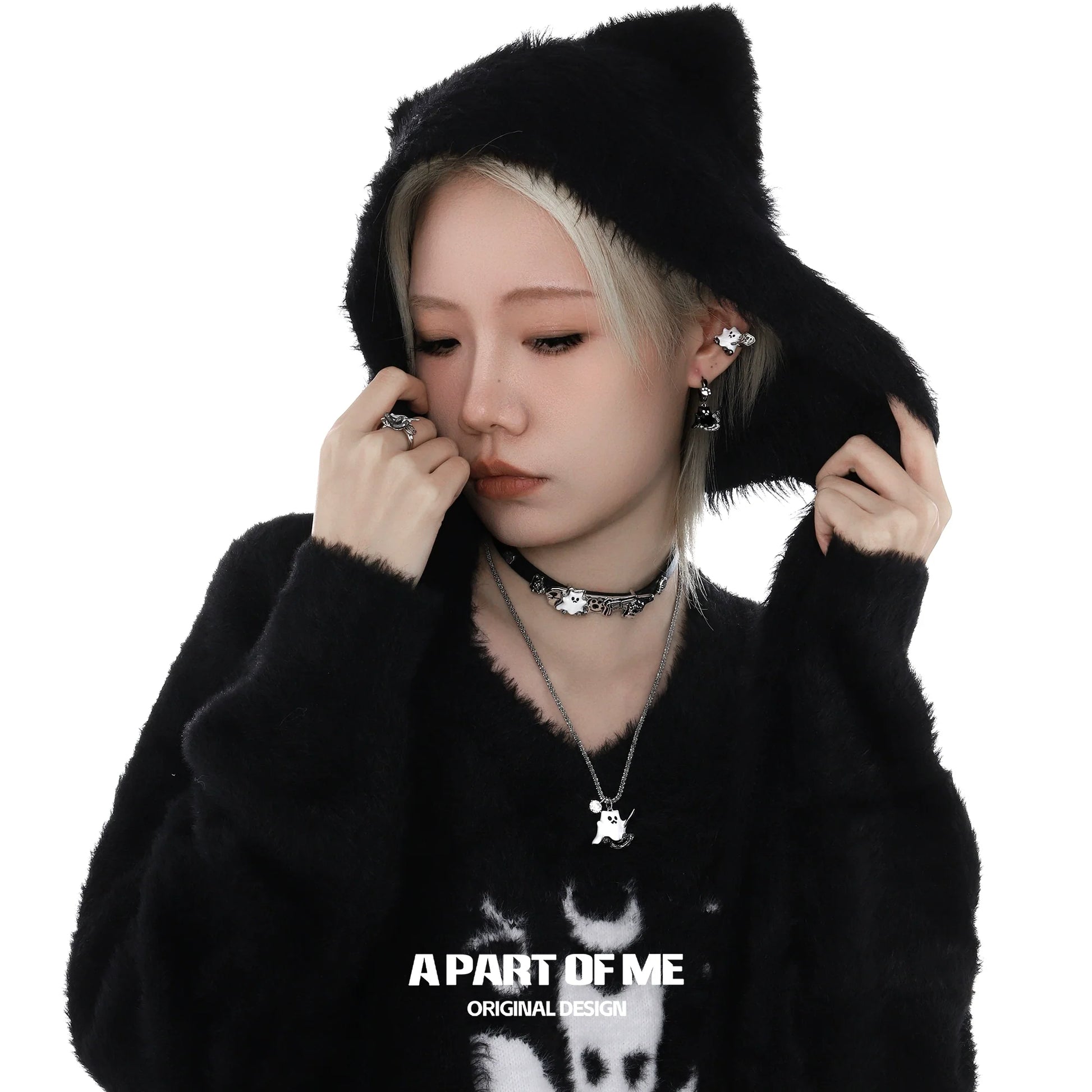 A PART OF ME kitten ghost leather choker worn by a model in a cozy black hoodie