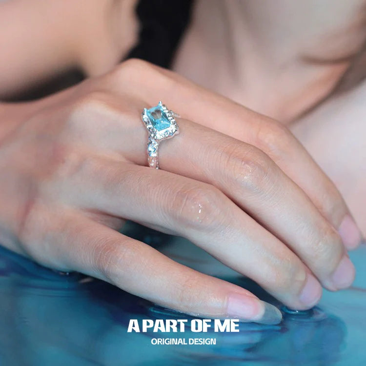 A Part of Me Mermaid Tears silver ring featuring a blue gemstone and intricate design on a hand