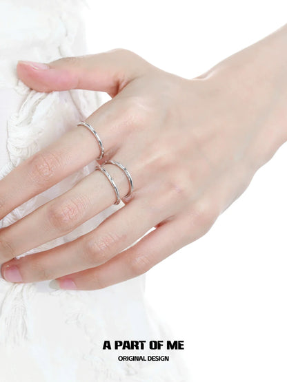 Close-up of minimalist stack rings worn on fingers for a stylish, modern look by A PART OF ME