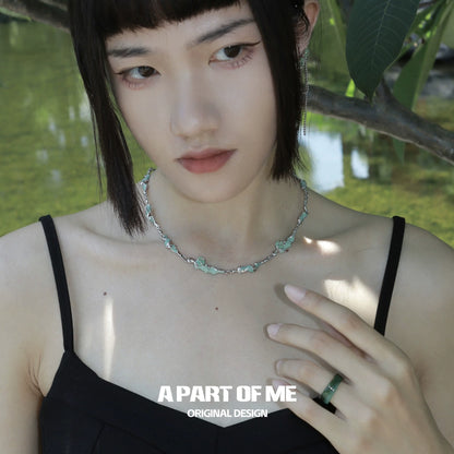 Fashion model wearing an opal anchor necklace highlighting its elegant design and gemstone details