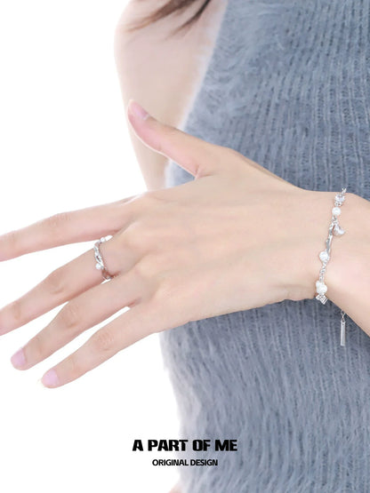 A PART OF ME pearl statement ring worn elegantly on a hand with a delicate bracelet