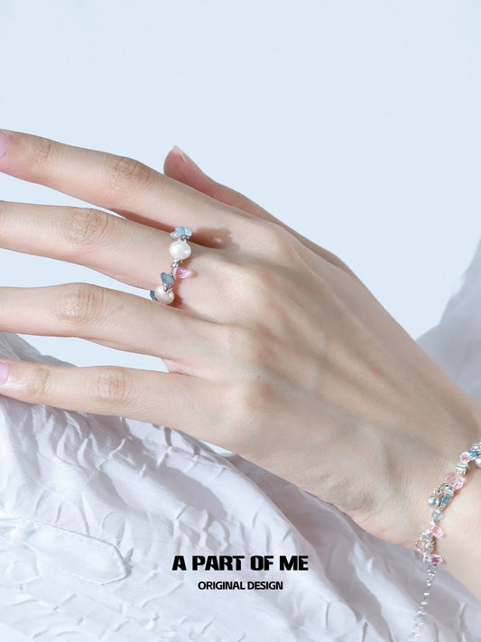 Delicate rainbow pearl ring featuring an elegant design with colorful pearls on a slender band