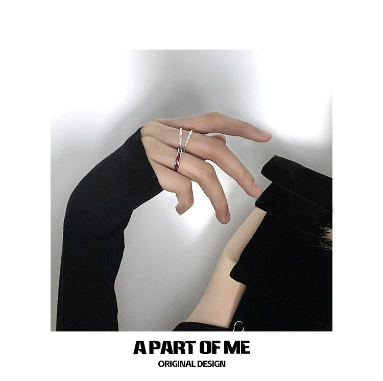 Stylish red venom couple rings showcased on a hand wearing a black sweater