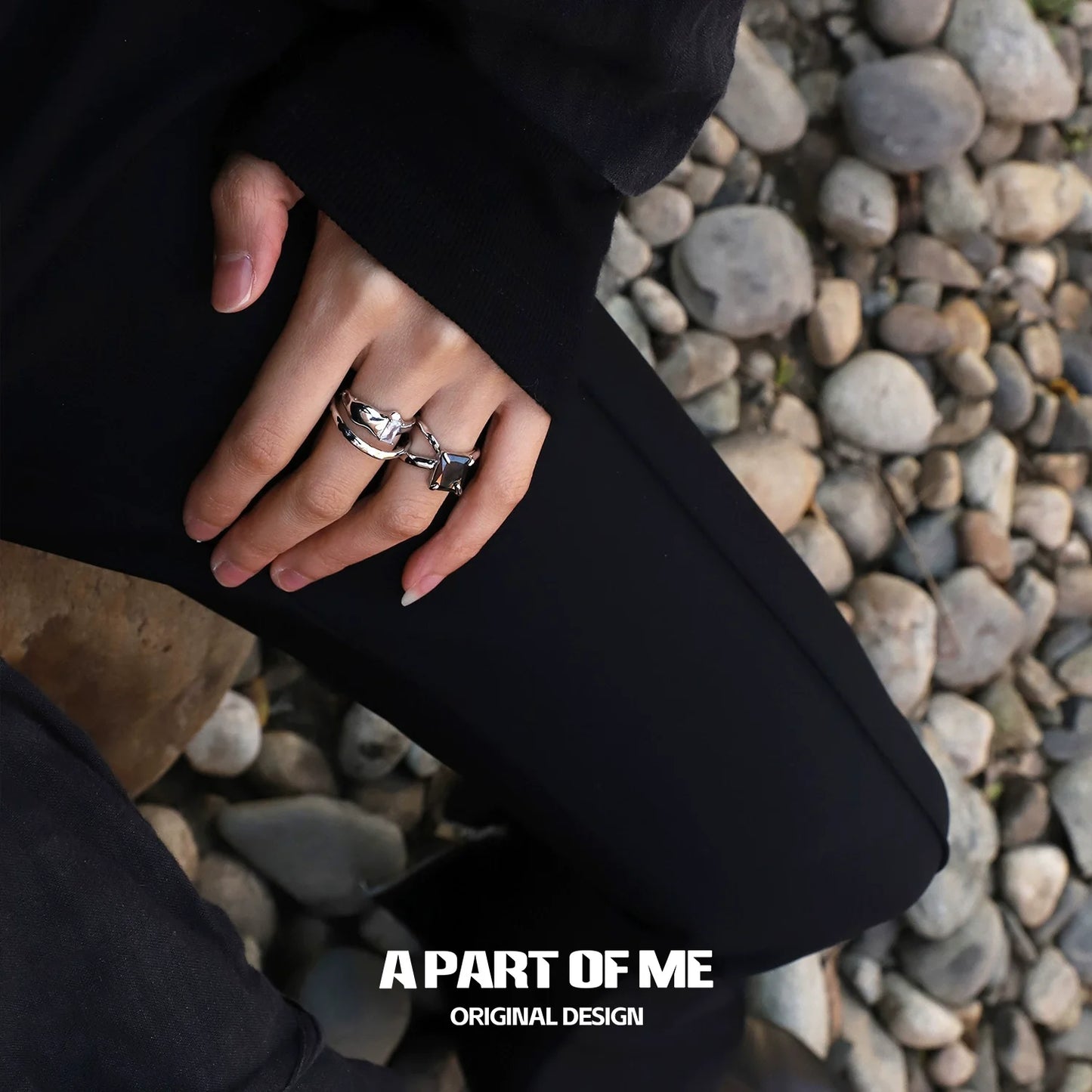 Stylish A PART OF ME savage claw hip-hop ring on a hand resting on stones