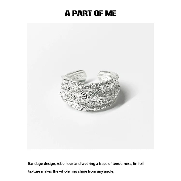 Silver bandage ring featuring a unique tin foil texture for a stylish and rebellious look