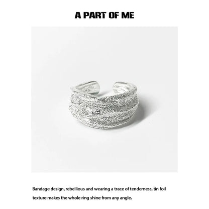 Silver bandage ring featuring a unique tin foil texture for a stylish and rebellious look