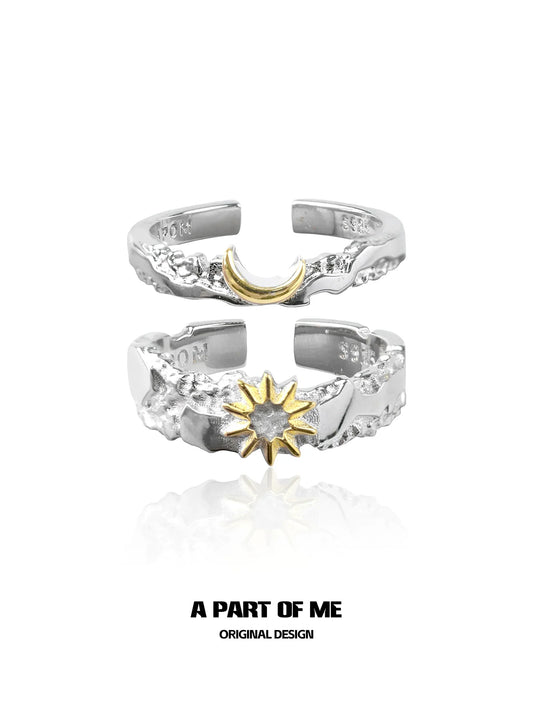 Silver sun and moon couple rings featuring a gold crescent moon and a gold sun design