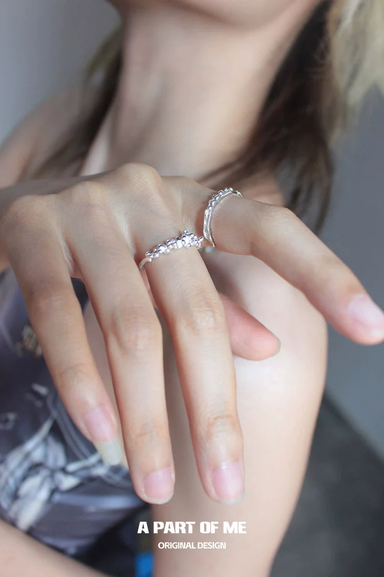 Stylish surf texture couple rings in silver worn on fingers for a trendy look