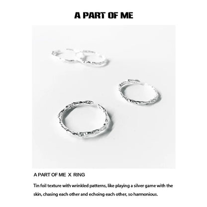 Textured silver rings with wrinkled patterns, showcasing a unique and harmonious design