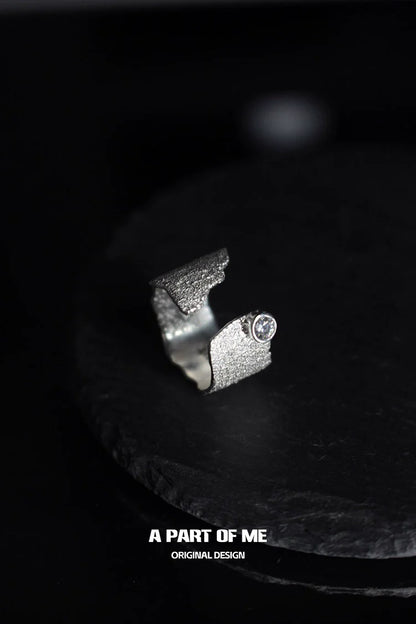 Textured silver travel ring with a unique design featuring a sparkling stone