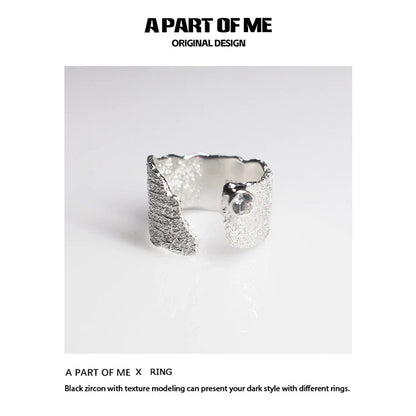 Textured silver travel ring from A PART OF ME showcasing a unique design with black zircon accents