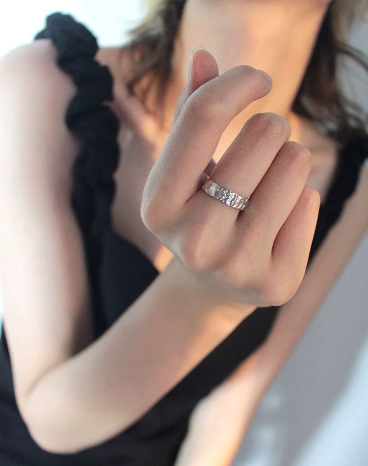 Stylish tinfoil crinkle punk ring worn on a finger, showcasing a unique textured design