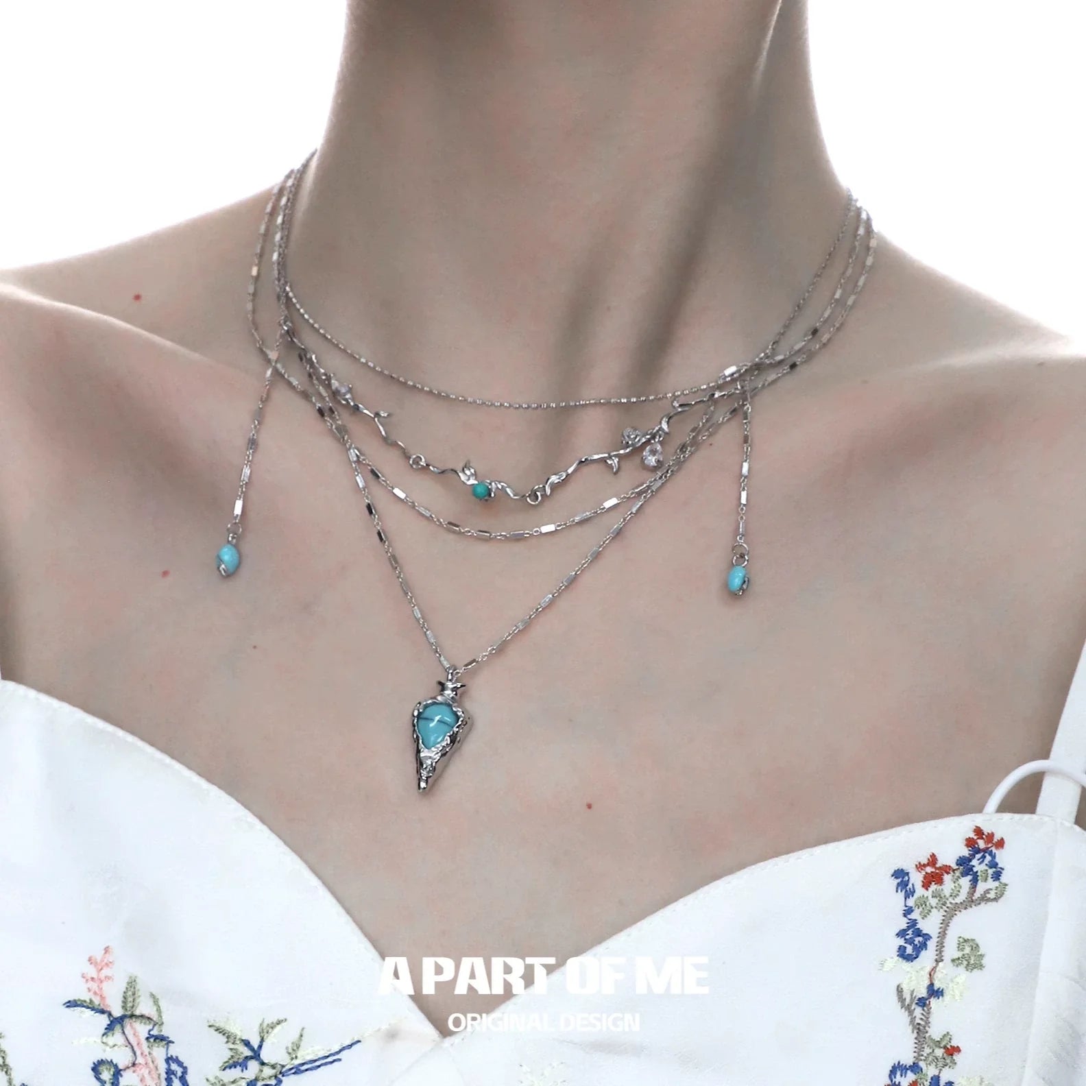 Turquoise boho charm necklace featuring layered silver chains and delicate turquoise accents