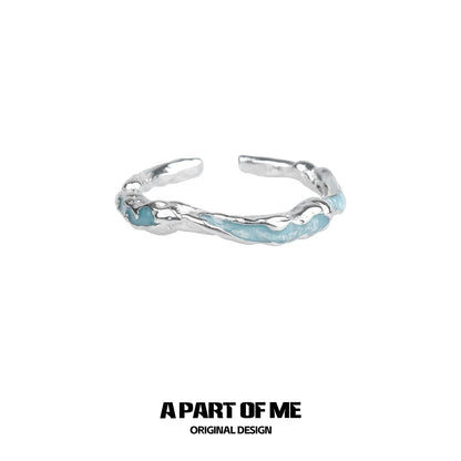 A PART OF ME White Orchid Love Ring with a unique twisted design and light blue accents