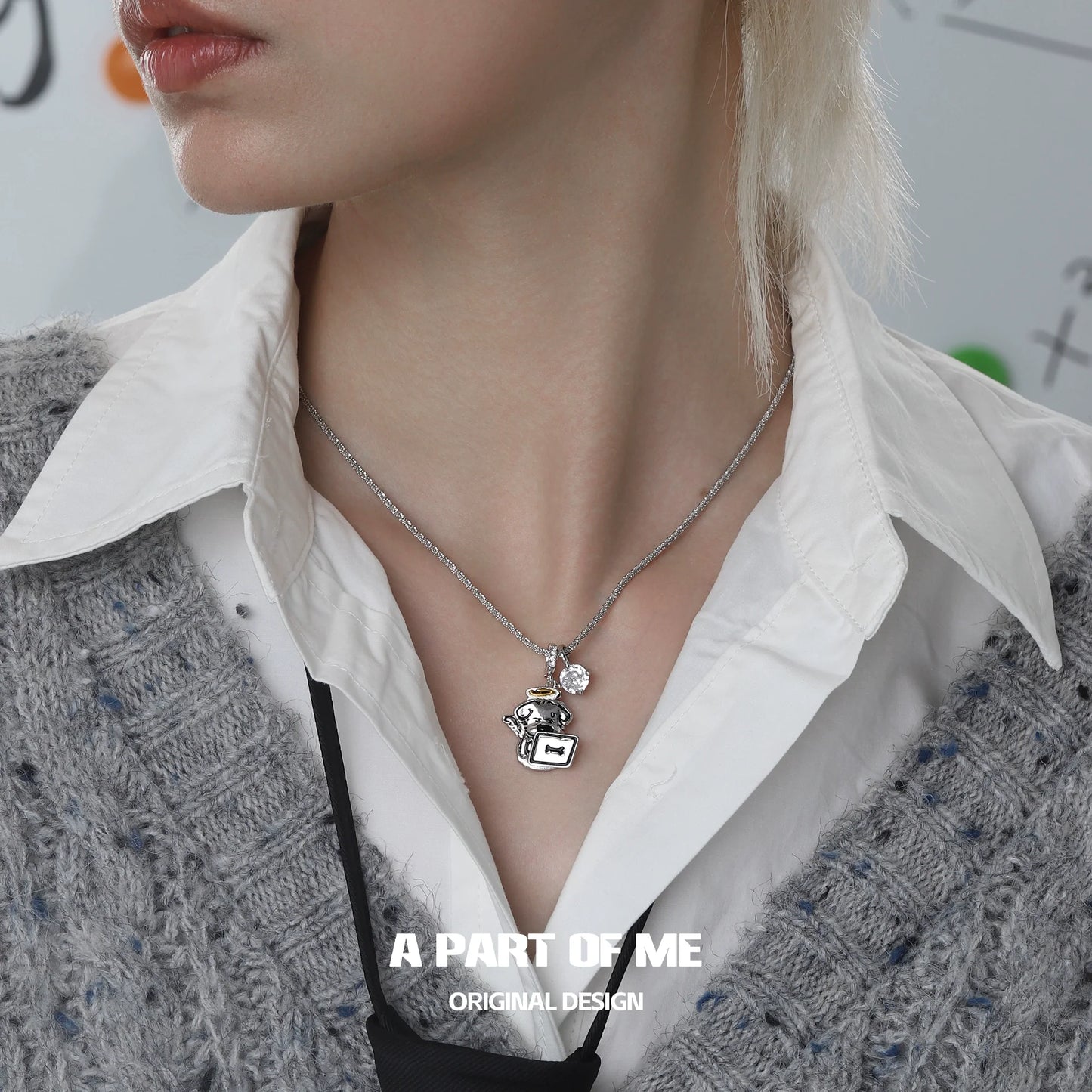 A PART OF ME working puppy necklace with silver charm and pendant worn on a model's neck