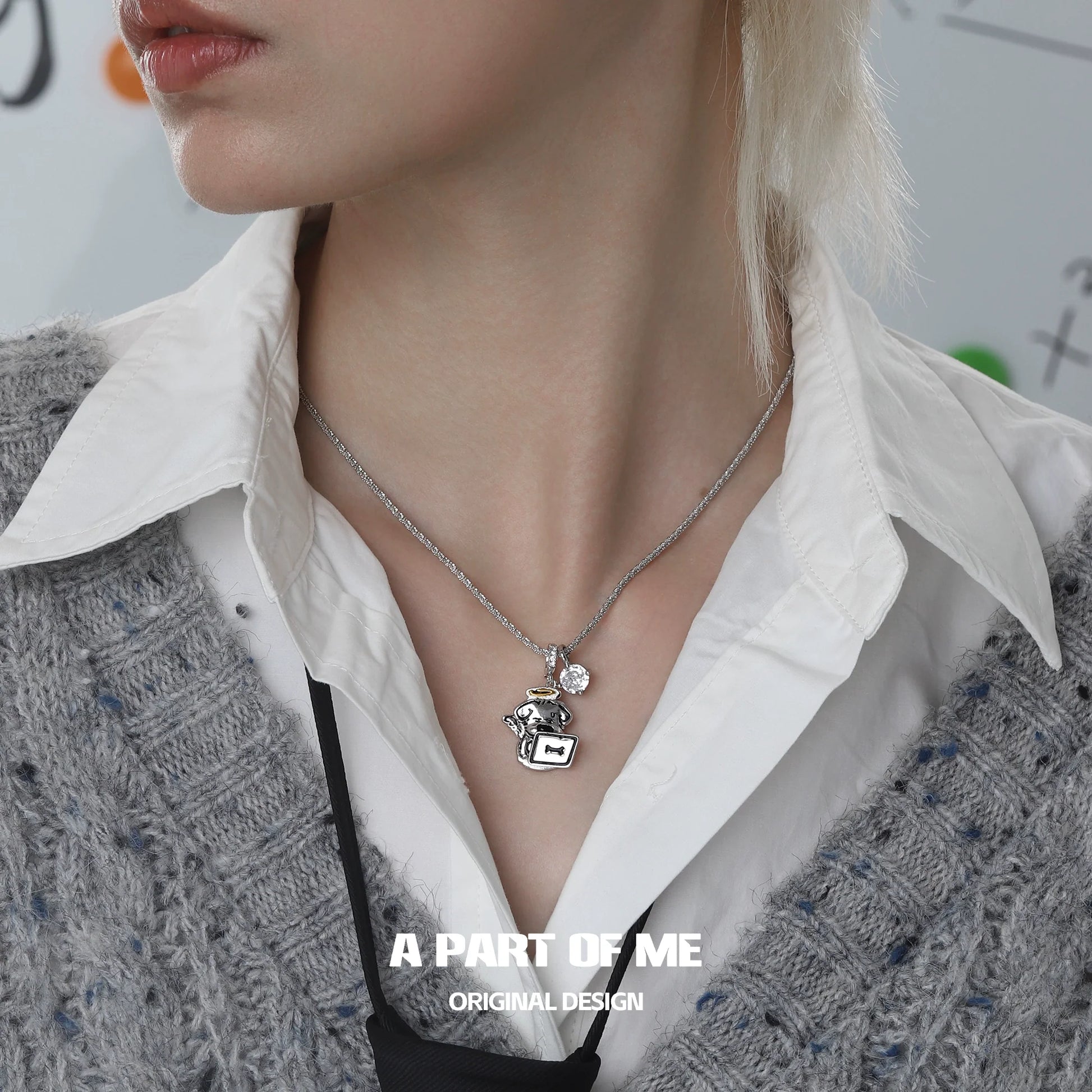 A PART OF ME working puppy necklace with silver charm and pendant worn on a model's neck