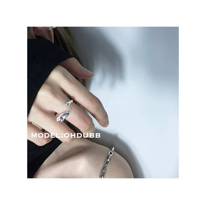 Y2K silver statement ring worn on a hand with a trendy outfit for a modern look