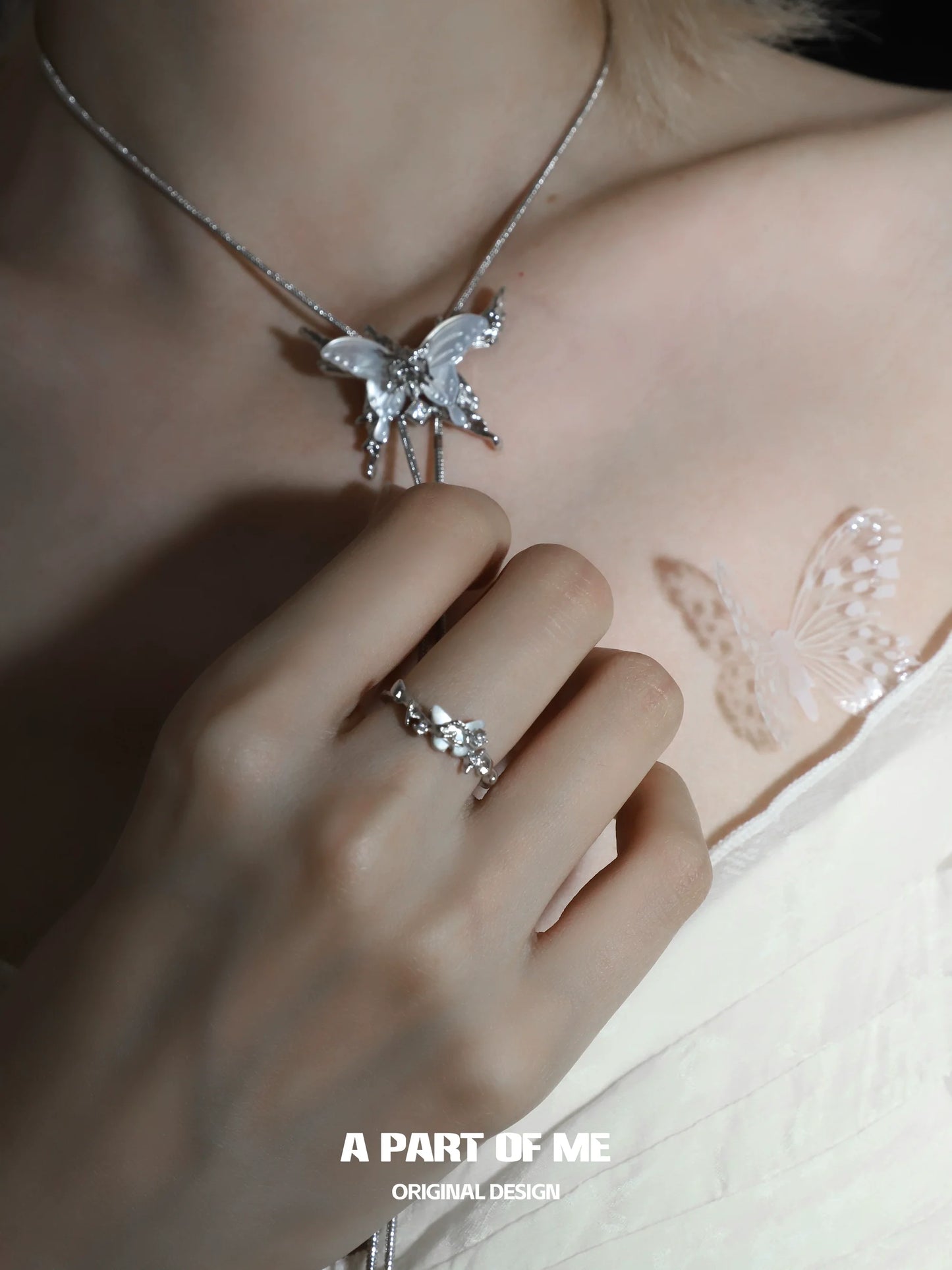 Elegant agate butterfly silver ring showcased on a hand, complementing a butterfly necklace