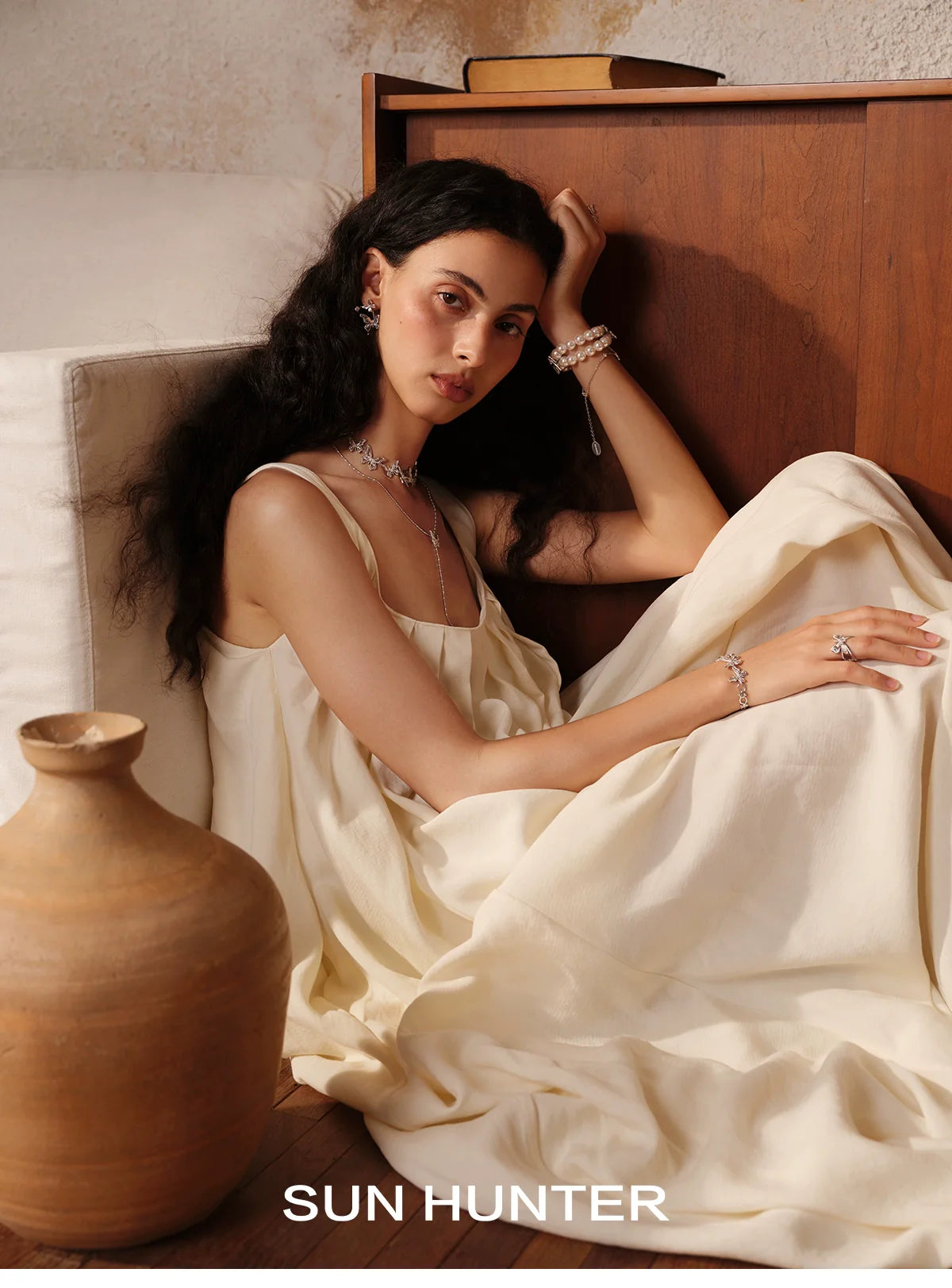 Elegant model wearing SUN HUNTER jewelry including an angel butterfly ring in a soft, minimalistic setting