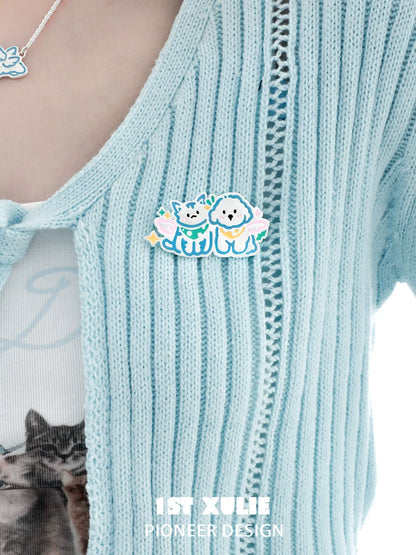 Cute angel cat and dog brooch featuring colorful design on a knitted cardigan