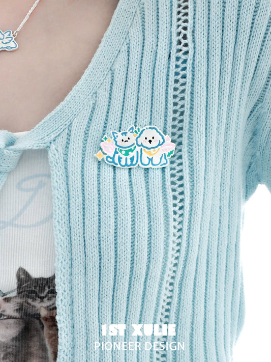 Cute angel cat and dog brooch featuring colorful design on a knitted cardigan