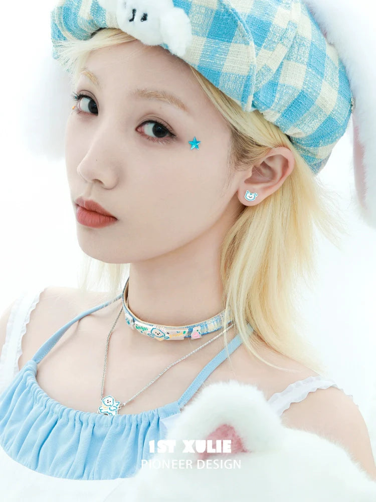 Cute angel cat and puppy earrings showcased on model wearing a blue outfit with pastel accessories