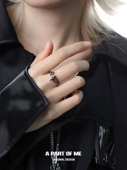A stylish black and white starlight ring worn on a finger, showcasing its unique star design.