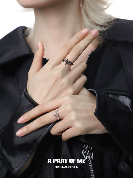 Elegant model showcasing a black and white starlight ring on delicate fingers