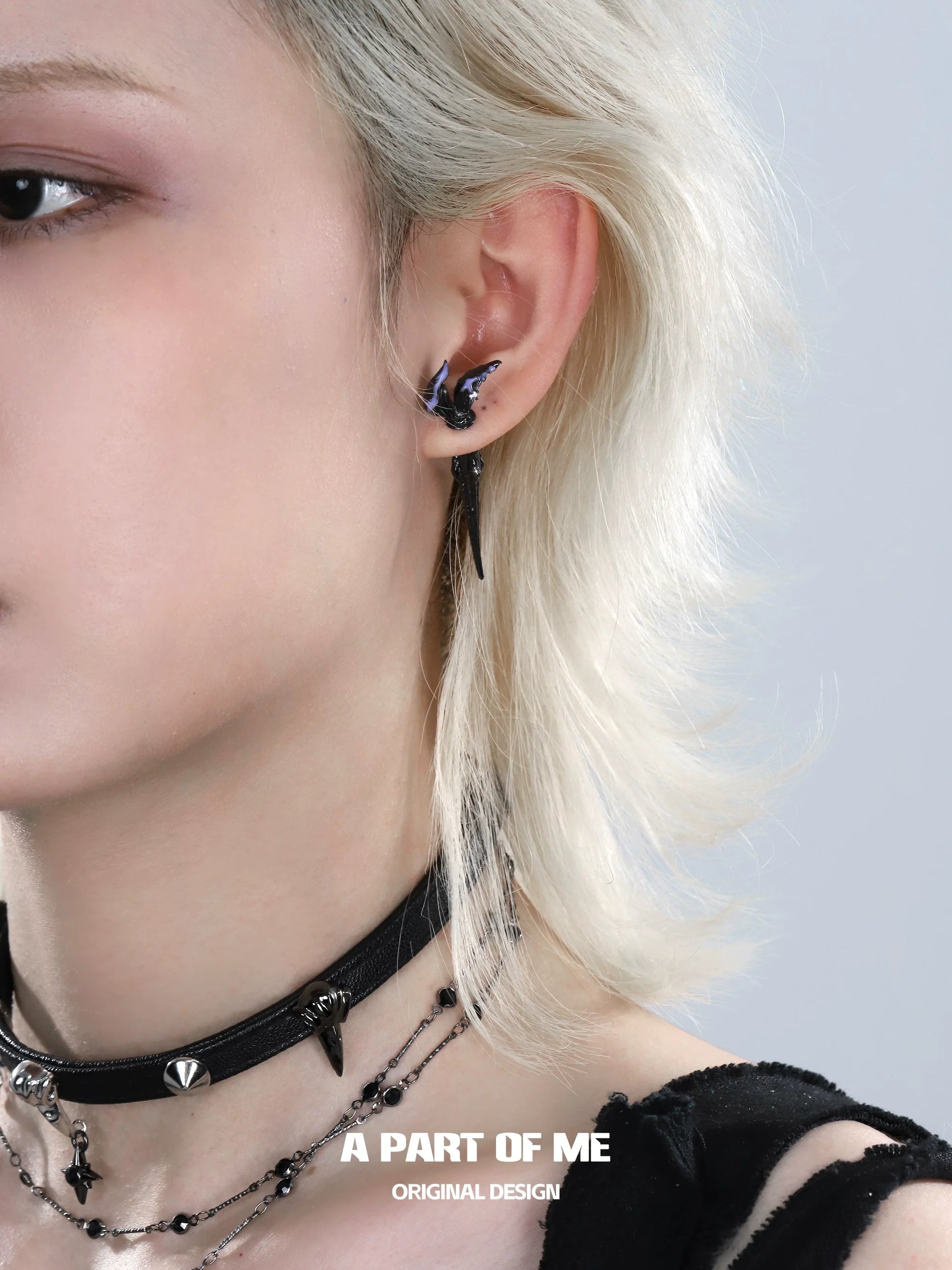 A PART OF ME fishtail dart sword earrings showcased on a model with edgy style