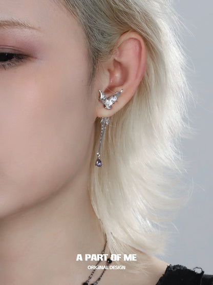 A Part of Me fishtail dart sword earrings featuring a unique design with a dangling gem