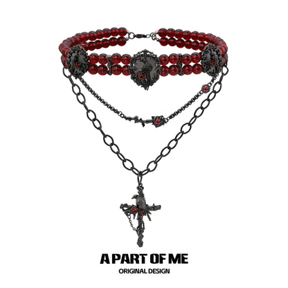 Gothic raven necklace featuring red beads and intricate black chain design from A PART OF ME