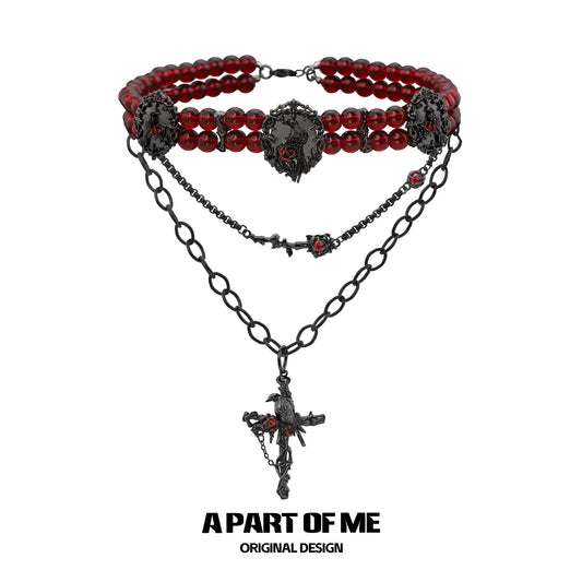 Gothic raven necklace featuring red beads and intricate black chain design from A PART OF ME