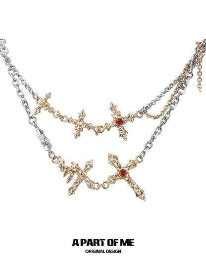 A PART OF ME liquid metal cross necklace with golden crosses and red gemstone accents