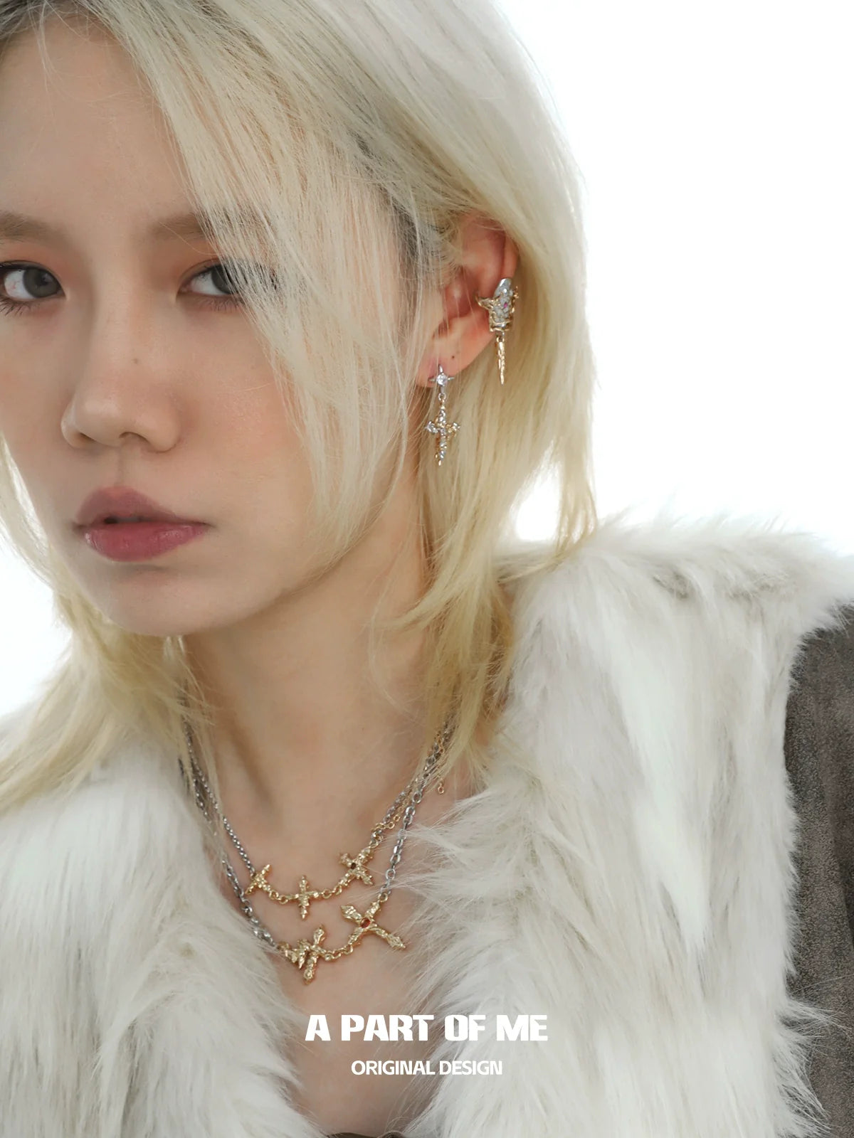 A PART OF ME liquid metal cross necklace displayed on a model showcasing elegant design and shine