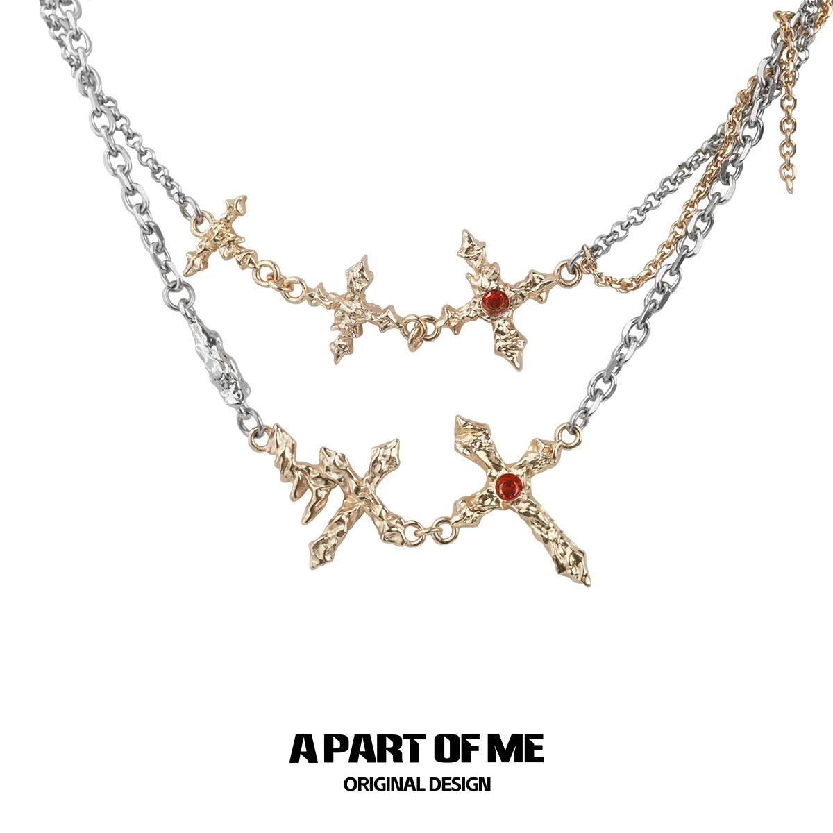 A PART OF ME liquid metal cross necklace in silver with intricate designs and red accents