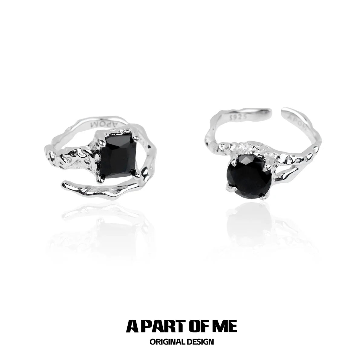 A pair of A PART OF ME midnight gem couple rings featuring black gemstones in a stylish twisted design