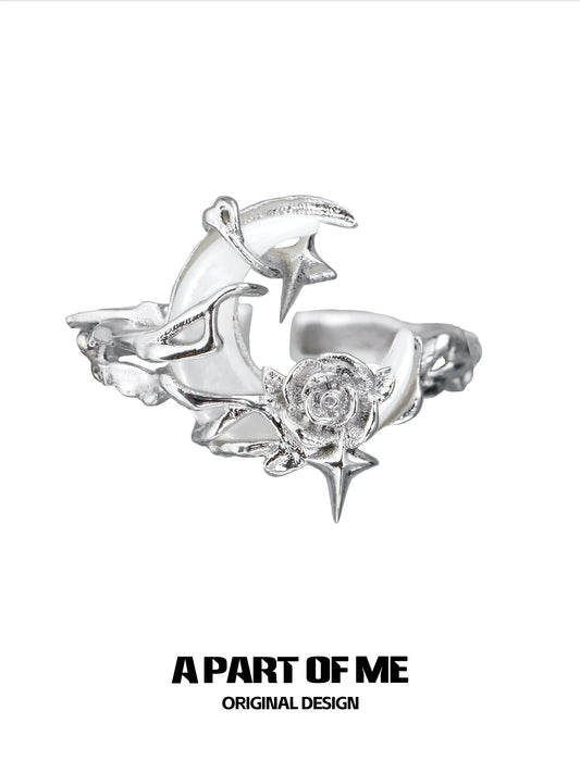 A beautiful moonlight rose silver ring featuring intricate star and rose designs