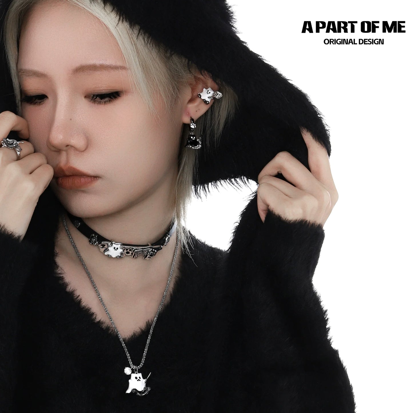 A PART OF ME weapon kitten devil necklace displayed on a model wearing a black hooded sweater