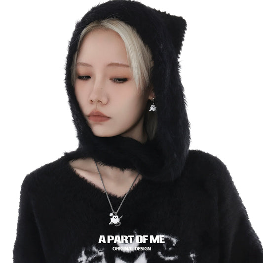 A woman wearing a black hoodie featuring a weapon kitten devil necklace from A PART OF ME