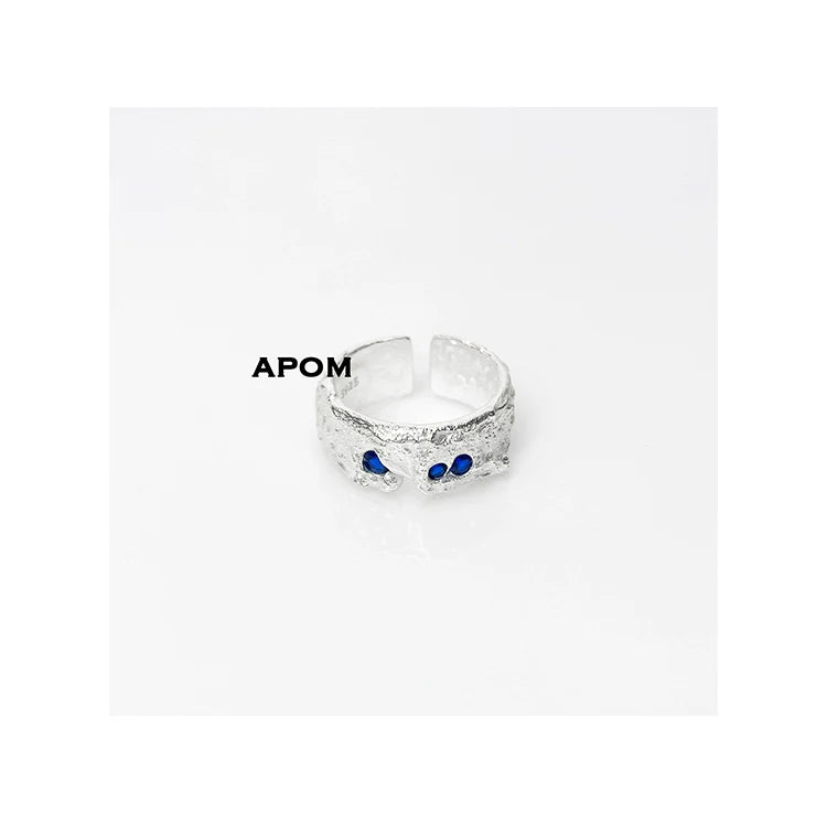 Stylish blue gemstone silver ring featuring a textured design and adjustable fit