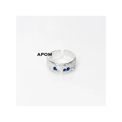 Stylish blue gemstone silver ring featuring a textured design and adjustable fit