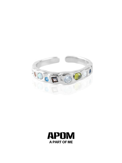 A PART OF ME rainbow gemstone ring featuring multiple colorful gemstones in a sleek silver band