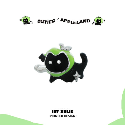 Playful black cat wearing colorful apple ear cuffs for pets by 1ST XULIE