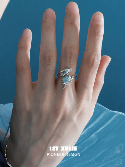 Stylish aquamarine dragon ring on a hand, showcasing intricate design and gemstone detail