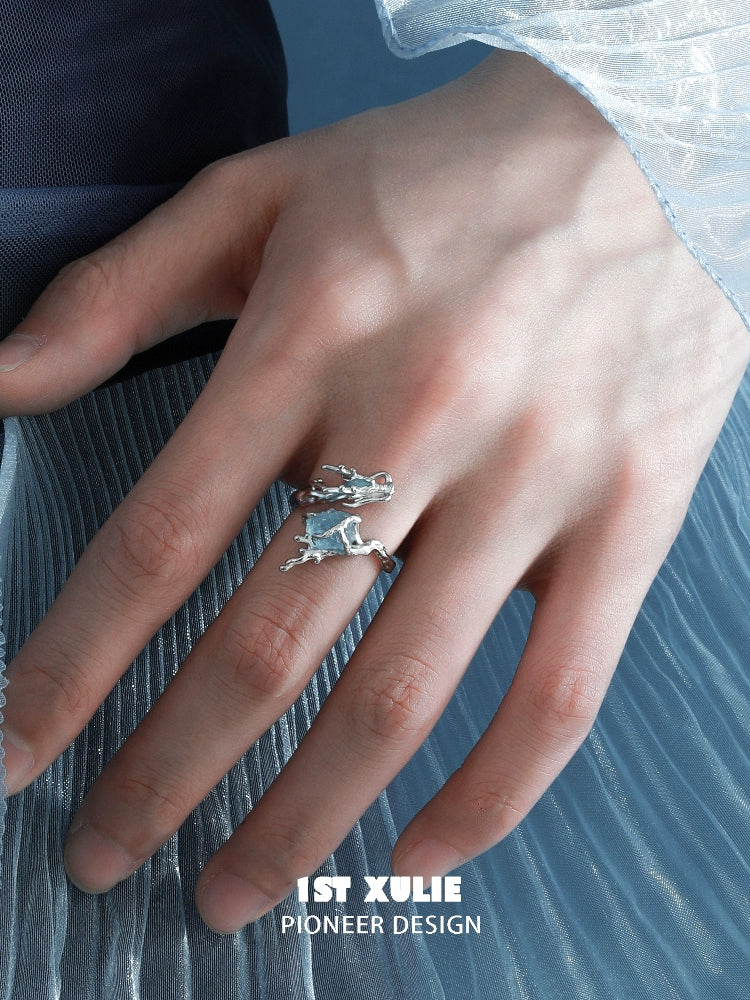 Detailed aquamarine dragon ring on a model's hand showcasing unique design and craftsmanship