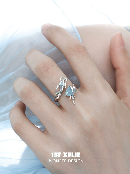 Elegant aquamarine dragon ring in silver, showcasing a unique design on a model's hand